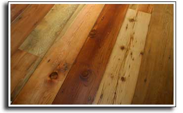 A reclaimed wood floor made from weathered barn siding, sanded and oil coated.